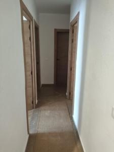 an empty hallway with two doors and a mirror at Apartamento Zafra Jaime in Zafra