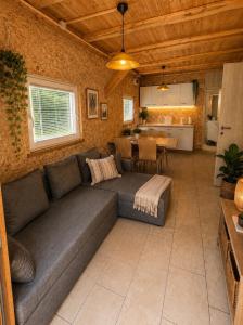 a living room with a couch and a kitchen at Bungalow Perun in Blejska Dobrava