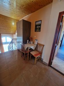 a dining room with a table and chairs at Alfa Apartman in Harkány