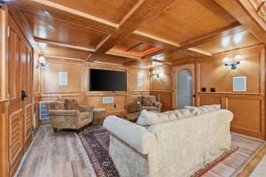 a living room with a couch and a tv at Sand Simeon - Relax, Unwind, Repeat in Chatham