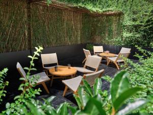 a group of tables and chairs in a garden at M Hotel in Hangzhou
