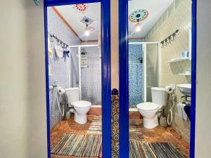 a bathroom with two toilets and a shower at Bluemoon house in Chefchaouen +108 photos