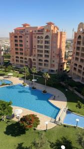 an overhead view of a large swimming pool with buildings at Marina Valley مارينا فالي in El Alamein