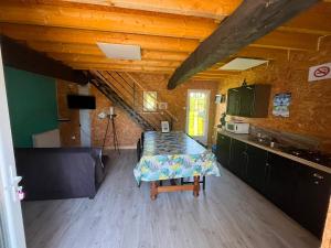 a kitchen with a table in the middle of a room at gite "La Renaudaie" - piscine in Juvigny-le-Tertre