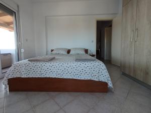 a bedroom with a large bed in a room at Marias Apartment in Kolymbia