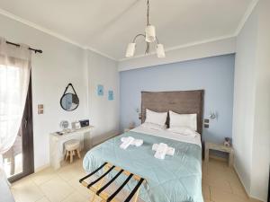 a bedroom with a bed with two towels on it at My Afytos Balcony in Afitos