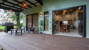 a patio with a table and chairs and a piano at Villa Alma Verde in Fortuna