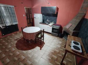 a kitchen with a table and a white refrigerator at Virgen del valle in Fiambalá