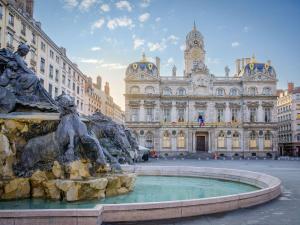 a fountain in front of a large building at greet Hotel Massieux Lyon Nord by All Accor in Massieux
