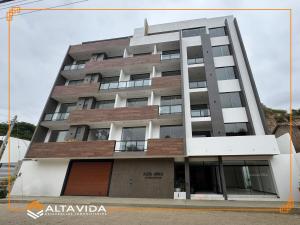 a tall apartment building with a lot of windows at Monoambiente Amplio in Tarija