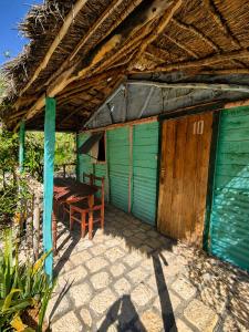 a hut with a table and a bench in front of it at Chez Émile in Anakao +6 photos