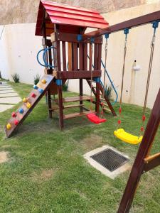 a playground with a slide and swings at Monoambiente Amplio in Tarija