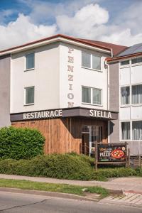 a building with a restaurant sign in front of it at Penzion Stella in Prostějov