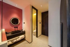 a bathroom with a sink and a mirror at M Hotel in Hangzhou +36 photos