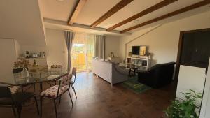 a living room with a table and a dining room at Casa Eira de Arriba - by entreRías in Cangas de Morrazo