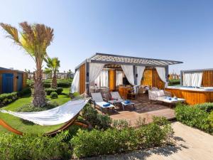 a backyard with a hammock and a house at Rixos Radamis Sharm El Sheikh in Sharm El Sheikh +143 photos