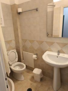 a bathroom with a toilet and a sink at Newquay beach club in Kavos +24 photos
