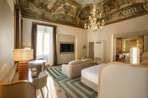 a hotel room with a bed and a living room at Rosetta Hotel Perugia Tapestry Collection By Hilton in Perugia