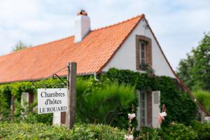 a sign in front of a house with a building at Roulotte du Rouard in Camiers +10 photos