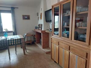 a living room with a dining table and a television at Panoramicissima in Costa Rei