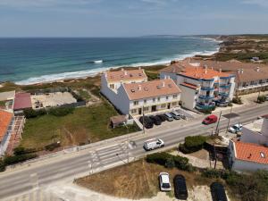 an aerial view of a building next to the ocean at Baleal Beach Haven - Surf, Sun & Sea in Ferrel