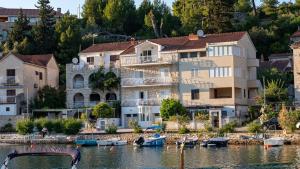 a group of houses on the water with boats at Zalazak in Bobovišća