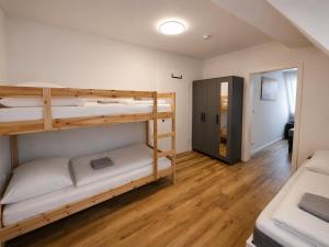 a room with two bunk beds and a hallway at Ferienwohnung Niki am Straussee Seeblick und Kamin für bis zu 12 Personen in Strausberg