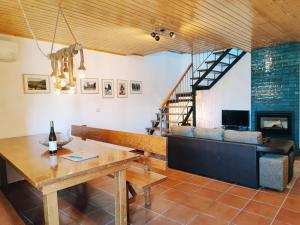 a living room with a table and a couch at Casa dos Côtos. in Castro Laboreiro