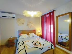 a bedroom with a bed and a large mirror at Casa dos Côtos. in Castro Laboreiro +33 photos