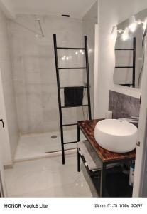 a bathroom with a sink and a shower at La Casa de Nona in Carcassonne
