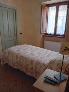 a bedroom with a bed and a desk with a keyboard at La Casa dei Nonni in Berceto +5 photos