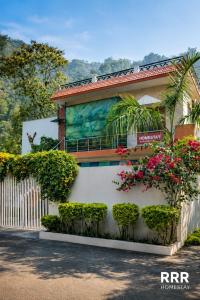 a building with flowers on the side of it at Ranibagh Riverview Retreat in Kāthgodām