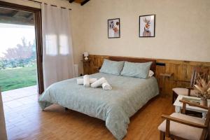 a bedroom with a bed with two towels on it at La Muralla de Gredos Hotel Rural in Madrigal de la Vera