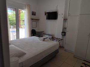 a bedroom with a bed with a towel on it at Iro's Cute House in Parikia