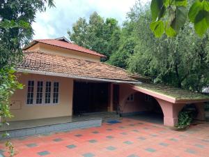 a small house with a red roof at Kalliyattu Homestay in Palakkad