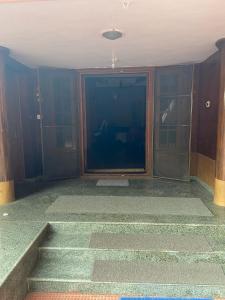 an empty room with stairs and glass doors at Kalliyattu Homestay in Palakkad +3 photos