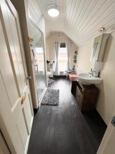 a bathroom with a sink and a toilet at Chip's House in Pennyburn