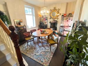 a dining room with a table and chairs at Chip's House in Pennyburn