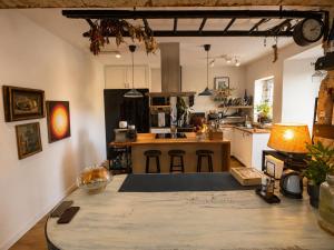 a kitchen with a table in the middle of a room at Holibai Mirada do Roxo 3 suites y vistas al mar in Oia