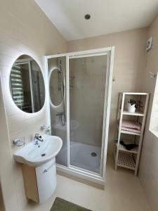 a bathroom with a shower and a sink at Zidinio Liepsnele in Palanga +22 photos