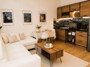 a living room with a white couch and a table at Dorian in Kos
