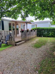 a house with a wooden porch with a bench at ZEN cocoon in Ivry-la-Bataille