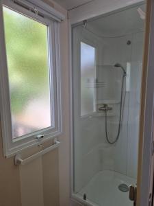 a bathroom with a shower and a glass window at ZEN cocoon in Ivry-la-Bataille +5 photos