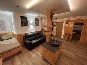 a living room with a couch and a table at Dorfblick Appartements & Rooms in Senales