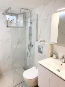 a bathroom with a shower and a toilet and a sink at G&D guest house in Ancient Epidauros