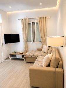 a living room with a bed and a couch at G&D guest house in Ancient Epidauros