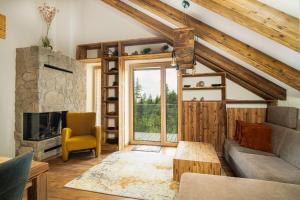 a living room with a couch and a fireplace at APLEND Hotel Ovruč in Štrbské Pleso