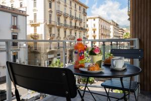 a table with a plate of food on a balcony at Garibaldi Suite B&B in Salerno