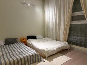 a bedroom with two beds and a window at Anhbnb in Danang