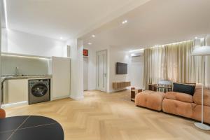 a living room with a couch and a table at The District Lekki by GCI in Lekki Phase 1